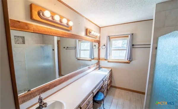 a room with wooden floor and windows