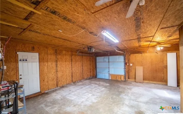 a view of empty room with ceiling fan