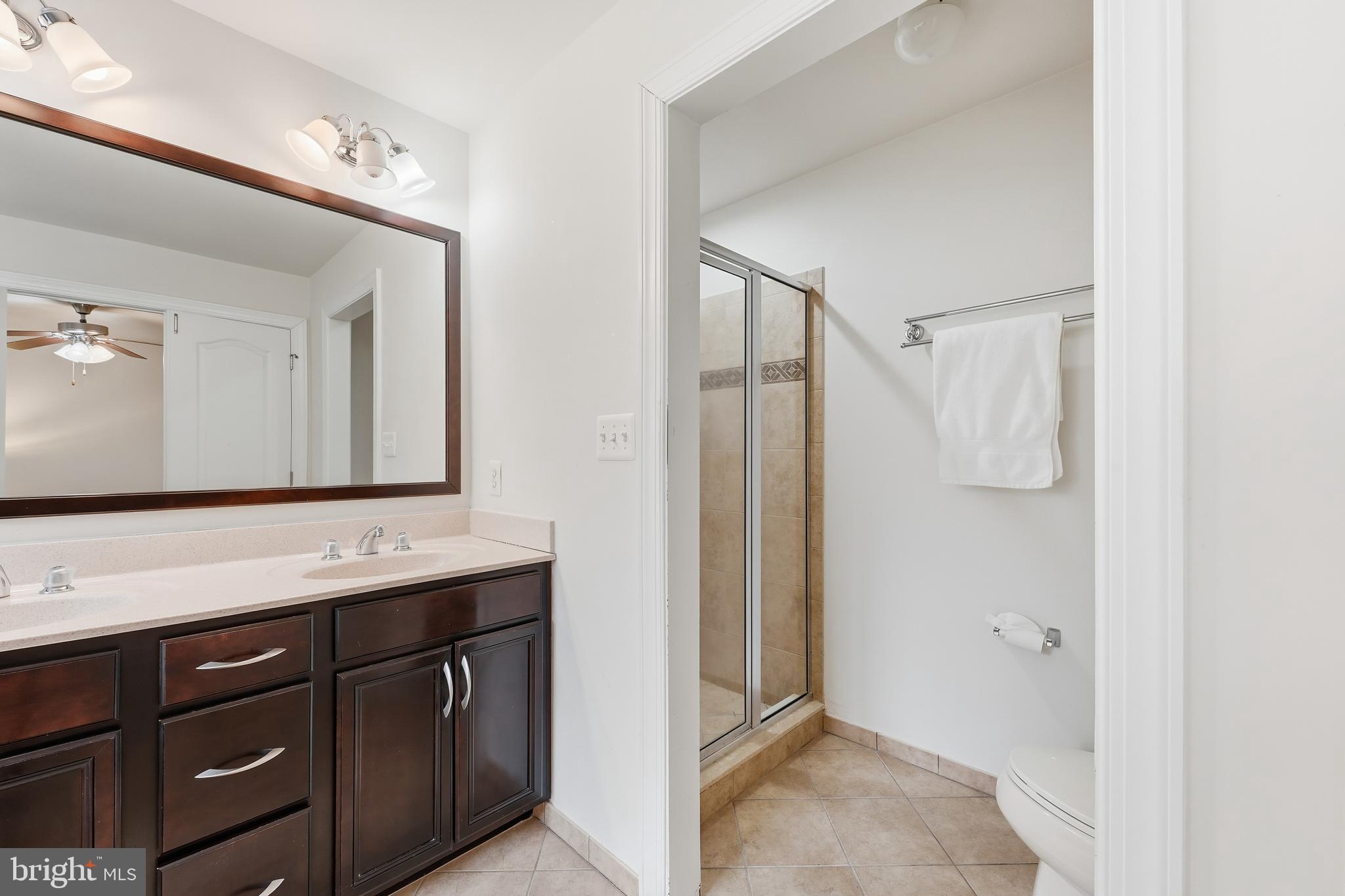 2284 Brimstone Place Hanover, MD 21076 - Photo 15 of 37 a bathroom with a shower sink and mirror