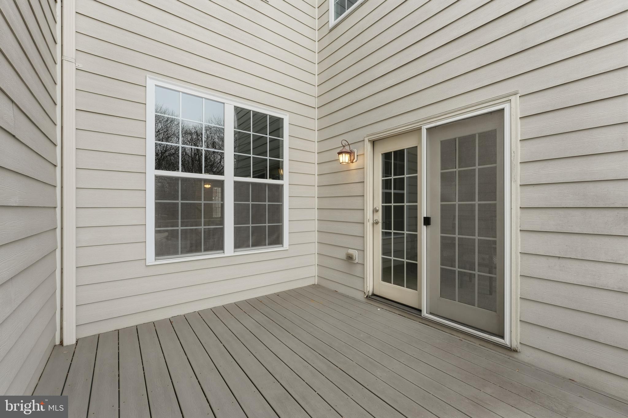 2284 Brimstone Place Hanover, MD 21076 - Photo 31 of 37 an empty room with wooden floor and windows