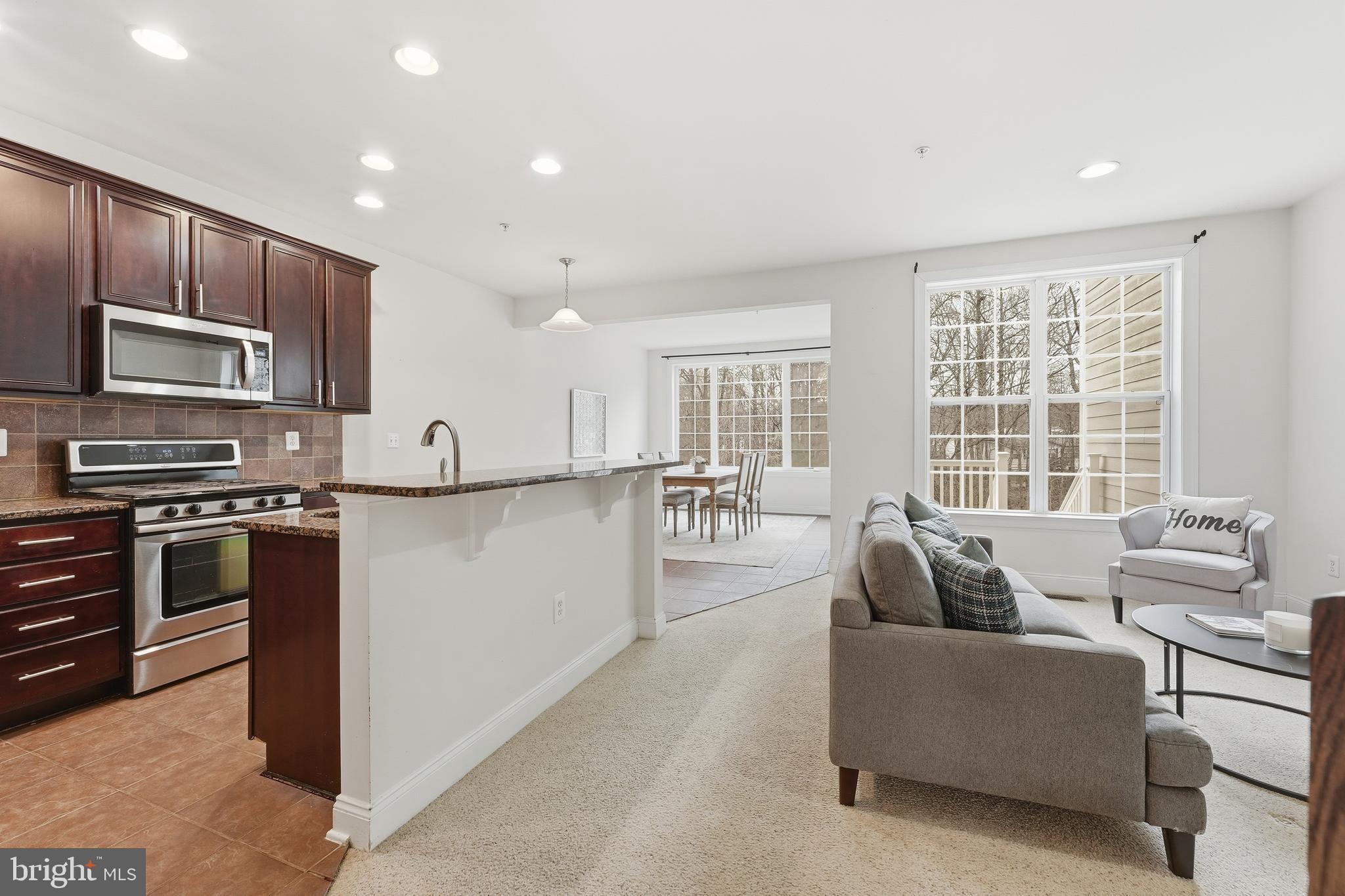 2284 Brimstone Place Hanover, MD 21076 - Photo 4 of 37 a living room with stainless steel appliances furniture and a kitchen view