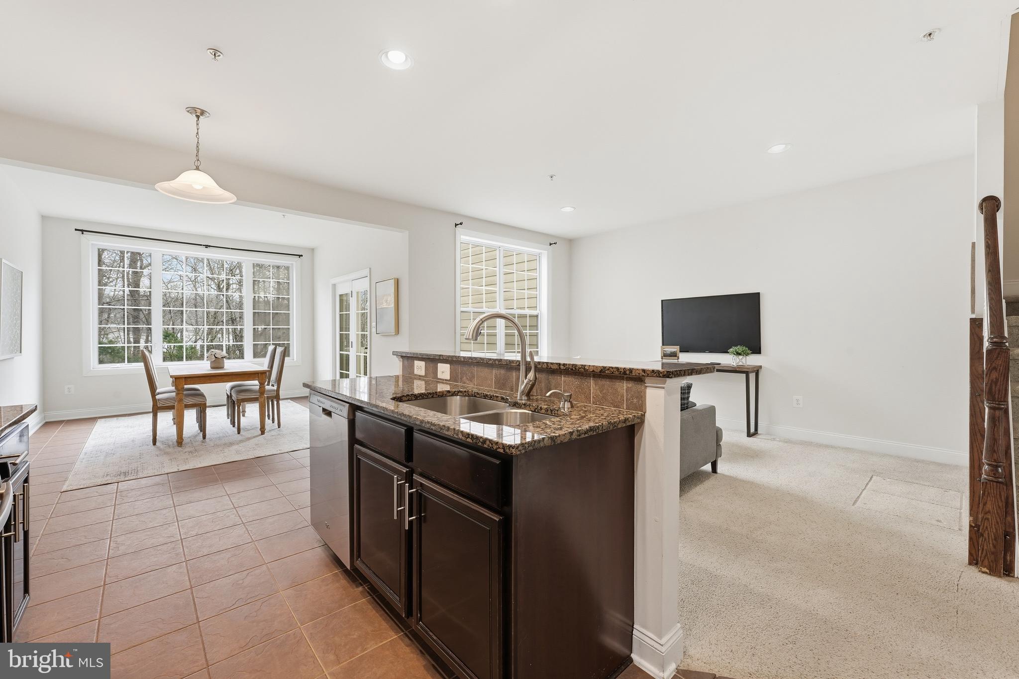 2284 Brimstone Place Hanover, MD 21076 - Photo 5 of 37 a kitchen with stainless steel appliances granite countertop a stove and a sink
