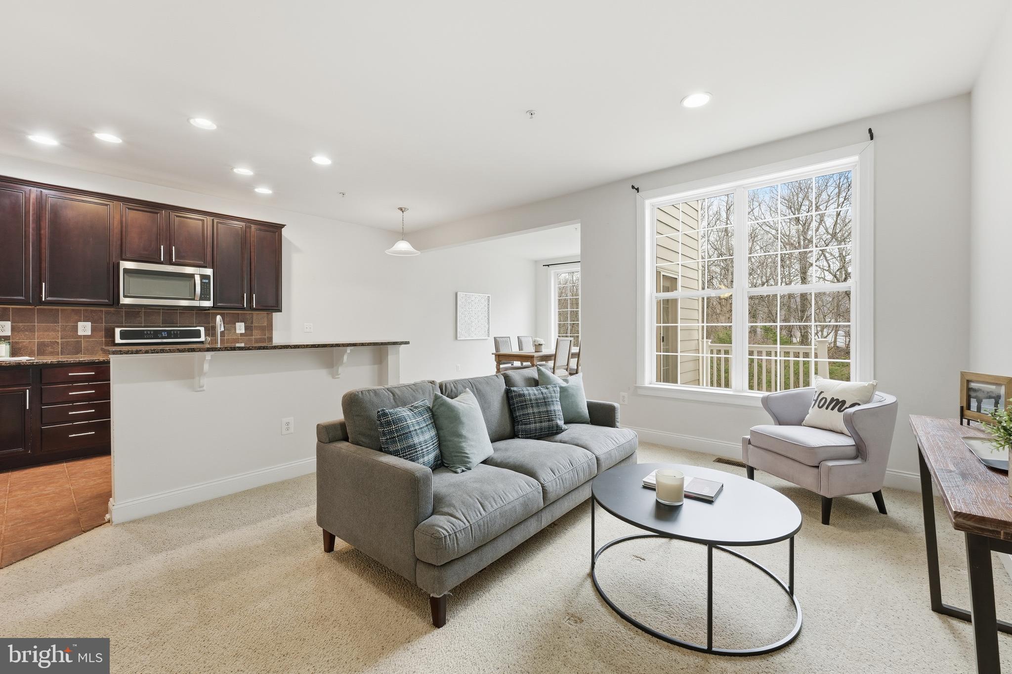 2284 Brimstone Place Hanover, MD 21076 - Photo 7 of 37 a living room with furniture and a large window