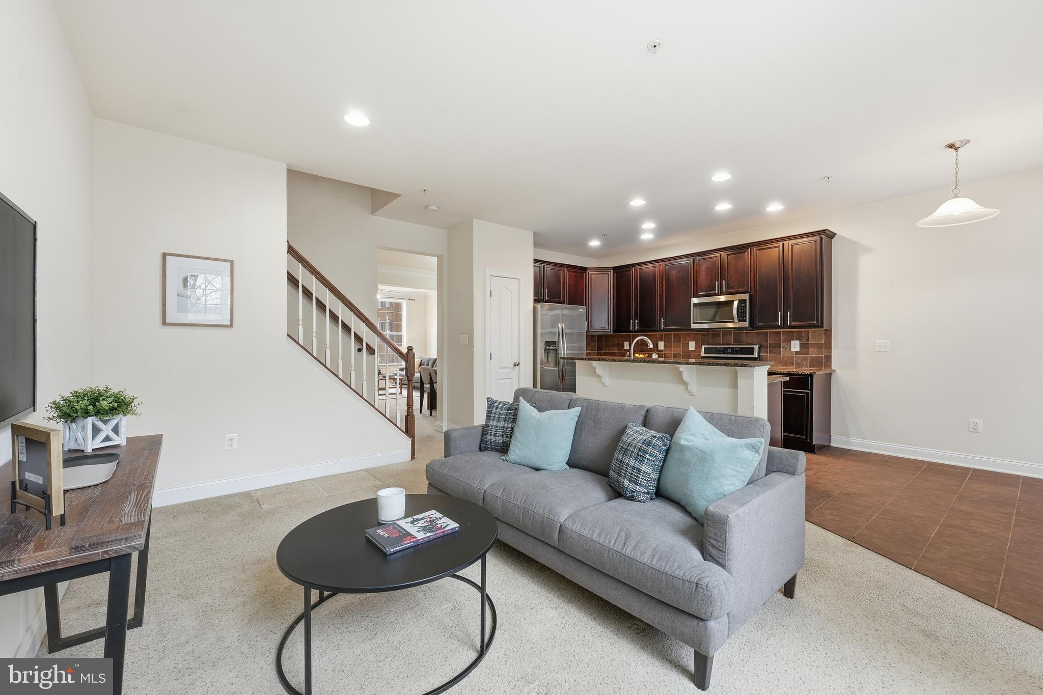 2284 Brimstone Place Hanover, MD 21076 - Photo 8 of 37 a living room with furniture and kitchen view