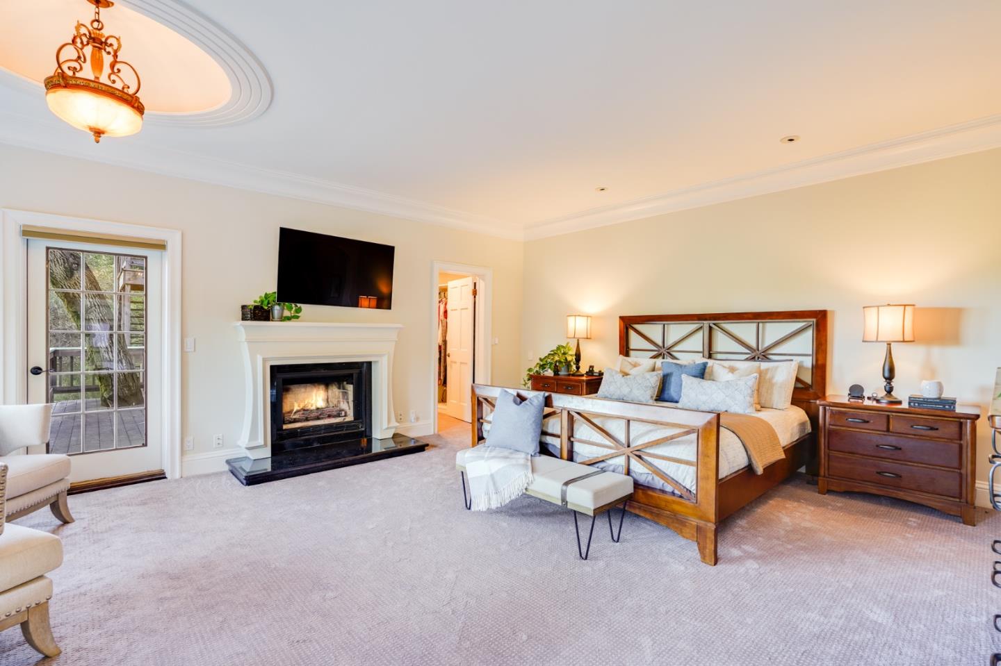 18565 Overlook Road Monte Sereno, CA 95030 - Photo 28 of 72 a bedroom with bed and a fireplace