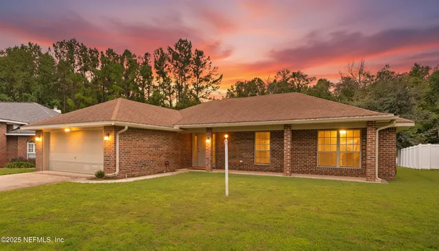 a backyard of a house with table and chairs