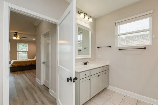 a bathroom with a sink a mirror and a shower