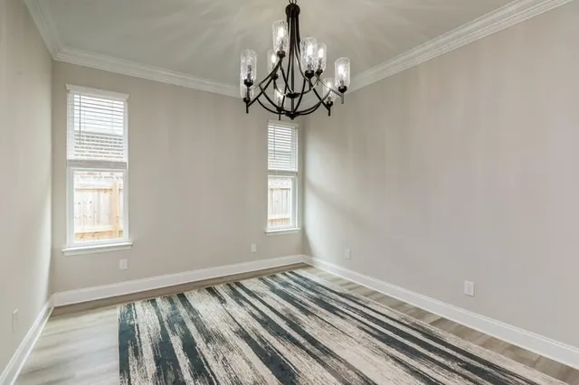 a view of a room with wooden floor and windows