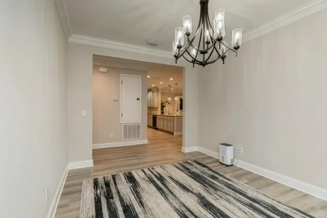 a view of a room with wooden floor and ceiling fan
