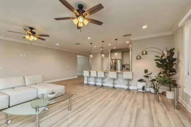 a living room with furniture and a chandelier