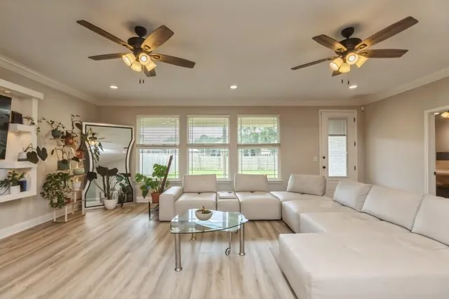a living room with furniture and wooden floor