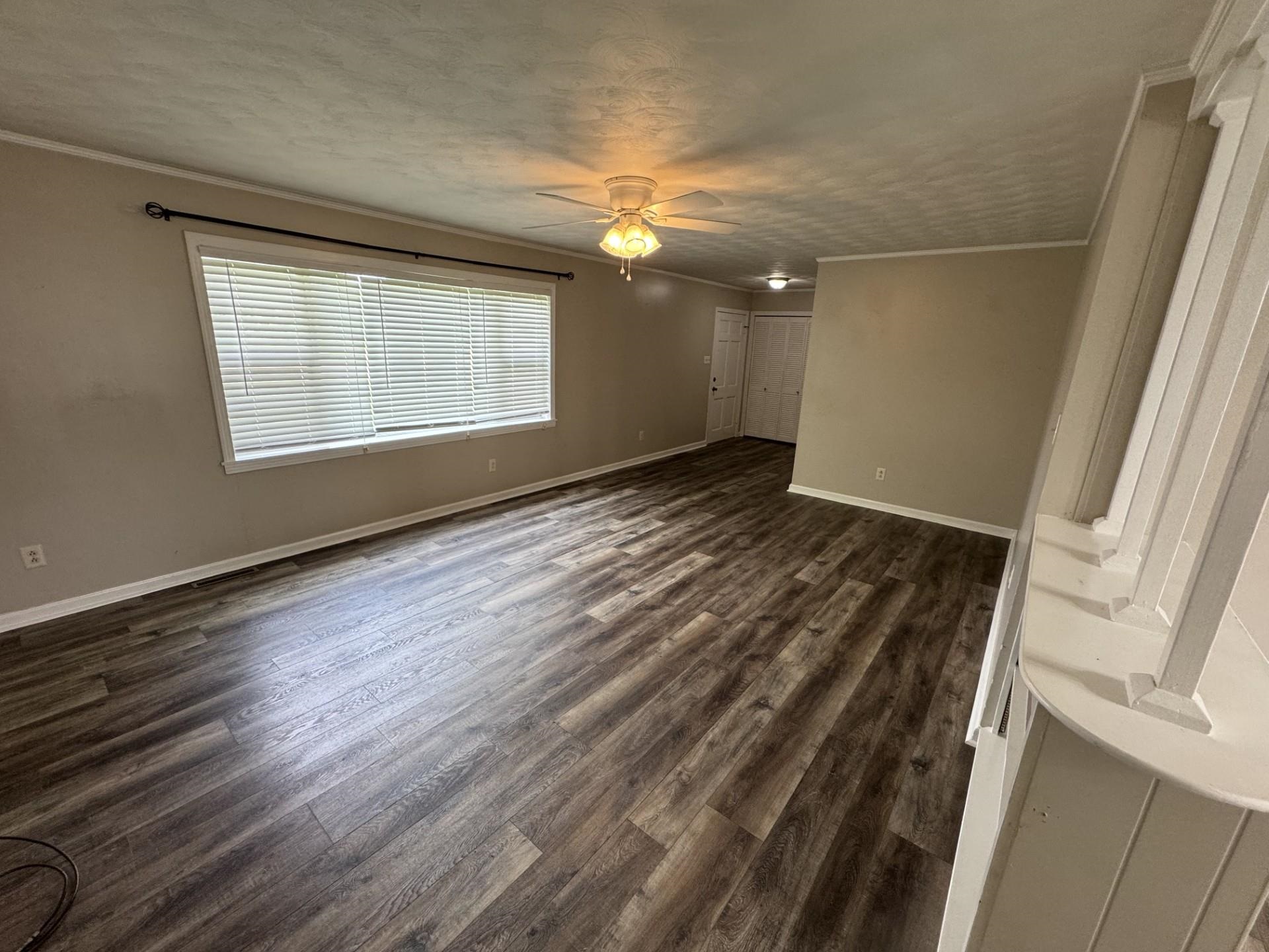 2631 Highway 51 Ripley, TN 38063 - Photo 13 of 17 an empty room with wooden floor and windows