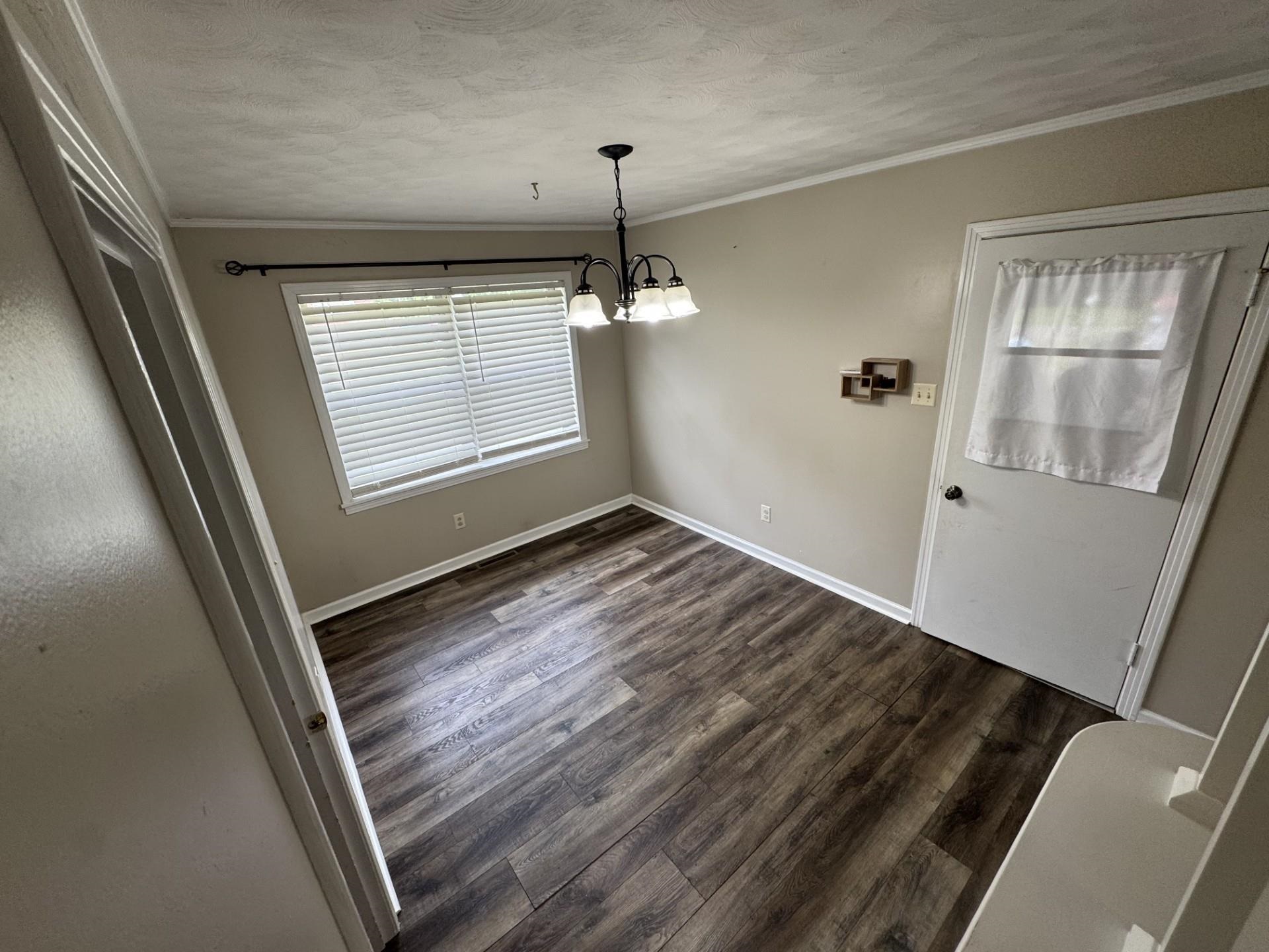 2631 Highway 51 Ripley, TN 38063 - Photo 7 of 17 a view of an empty room with wooden floor and a window