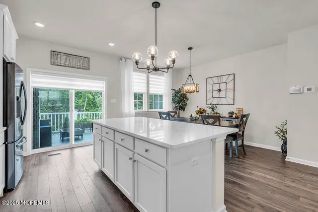 a kitchen with counter top space and wooden floor