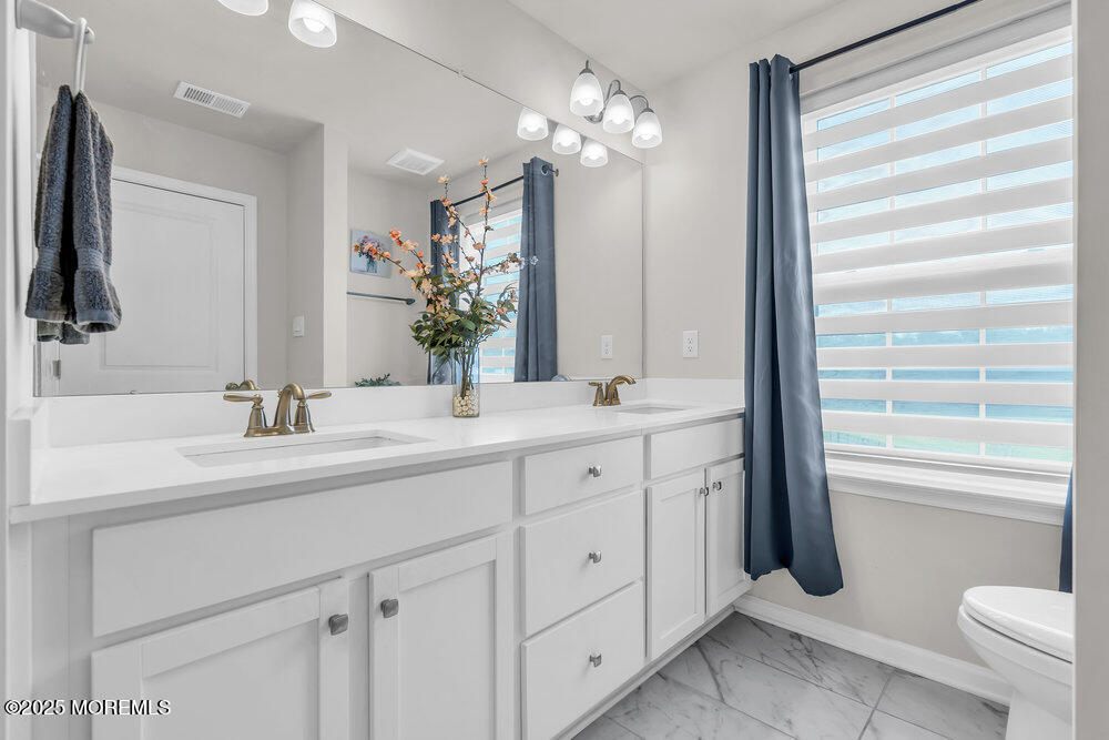 8 Avalon Lane Jackson, NJ 08527 - Photo 16 of 30 a bathroom with a double vanity sink and a mirror