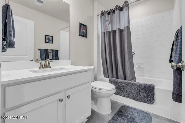 a bathroom with a sink toilet a mirror and shower