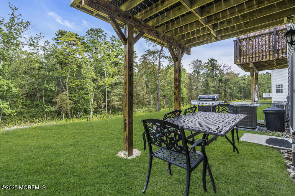 8 Avalon Lane Jackson, NJ 08527 - Photo 22 of 30 a view of a chairs and table in patio with a backyard