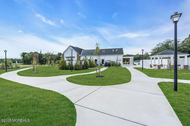 a view of a house with a big yard and potted plants