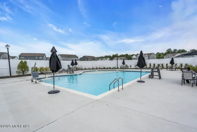 a view of a swimming pool and lounge chair