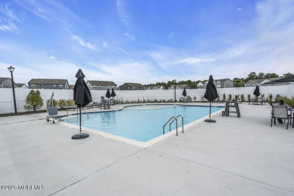 8 Avalon Lane Jackson, NJ 08527 - Photo 27 of 30 a view of a swimming pool and lounge chair