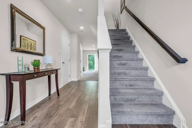 a view of entryway and hall with wooden floor