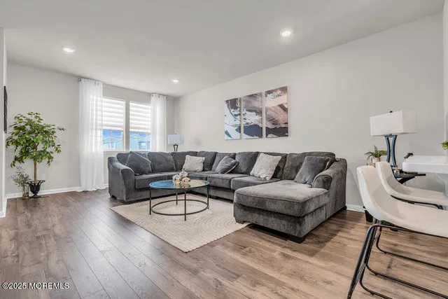 a living room with furniture potted plant and a window