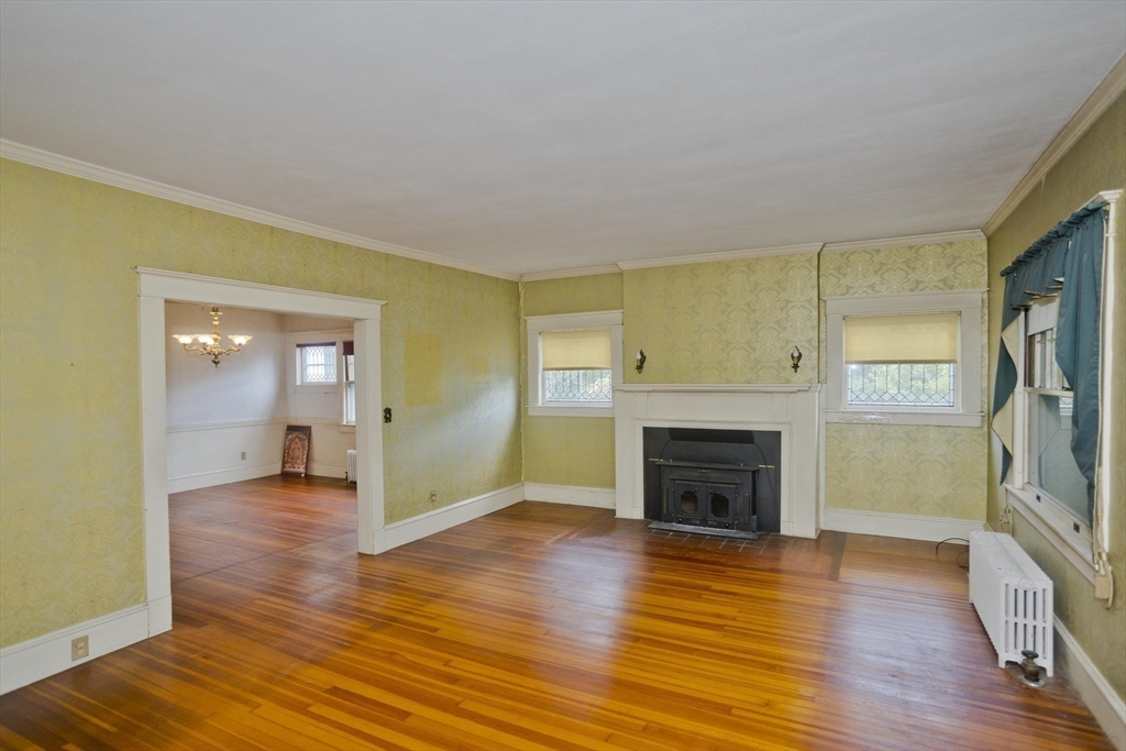 83 Mountain Road Wilbraham, MA 01095 - Photo 12 of 42 a view of a livingroom with wooden floor and a fireplace