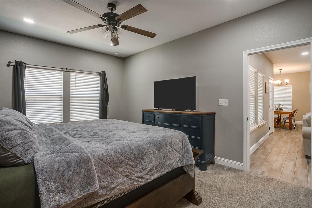 409 Titus Drive Springtown, TX 76082 - Photo 22 of 39 a bedroom with a bed and a flat screen tv