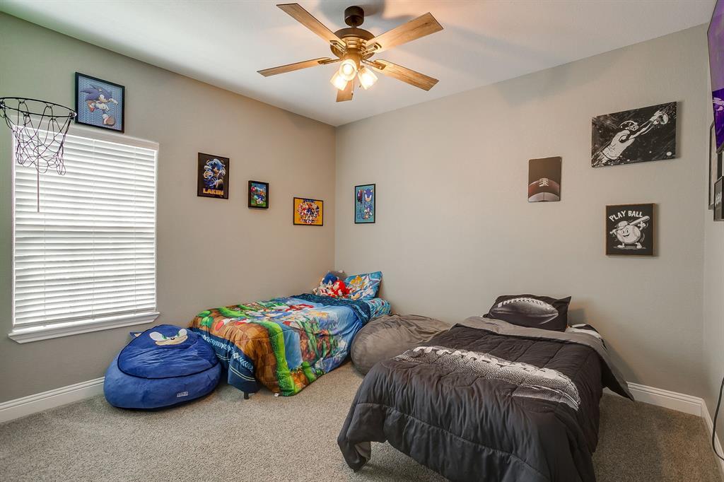 409 Titus Drive Springtown, TX 76082 - Photo 31 of 39 a bedroom with two beds and a window