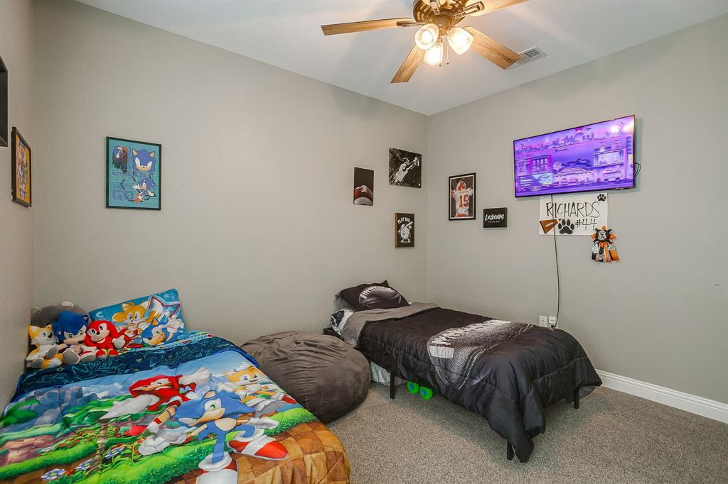409 Titus Drive Springtown, TX 76082 - Photo 32 of 39 a bedroom with furniture and a baby bed