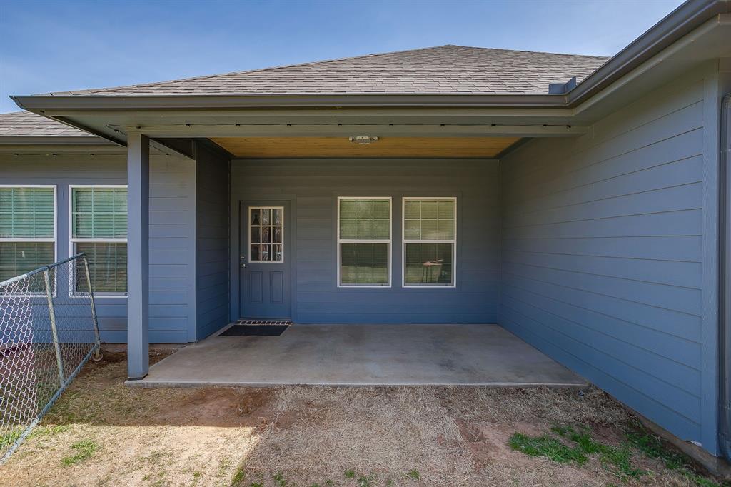 409 Titus Drive Springtown, TX 76082 - Photo 37 of 39 a view of outdoor space and a front door