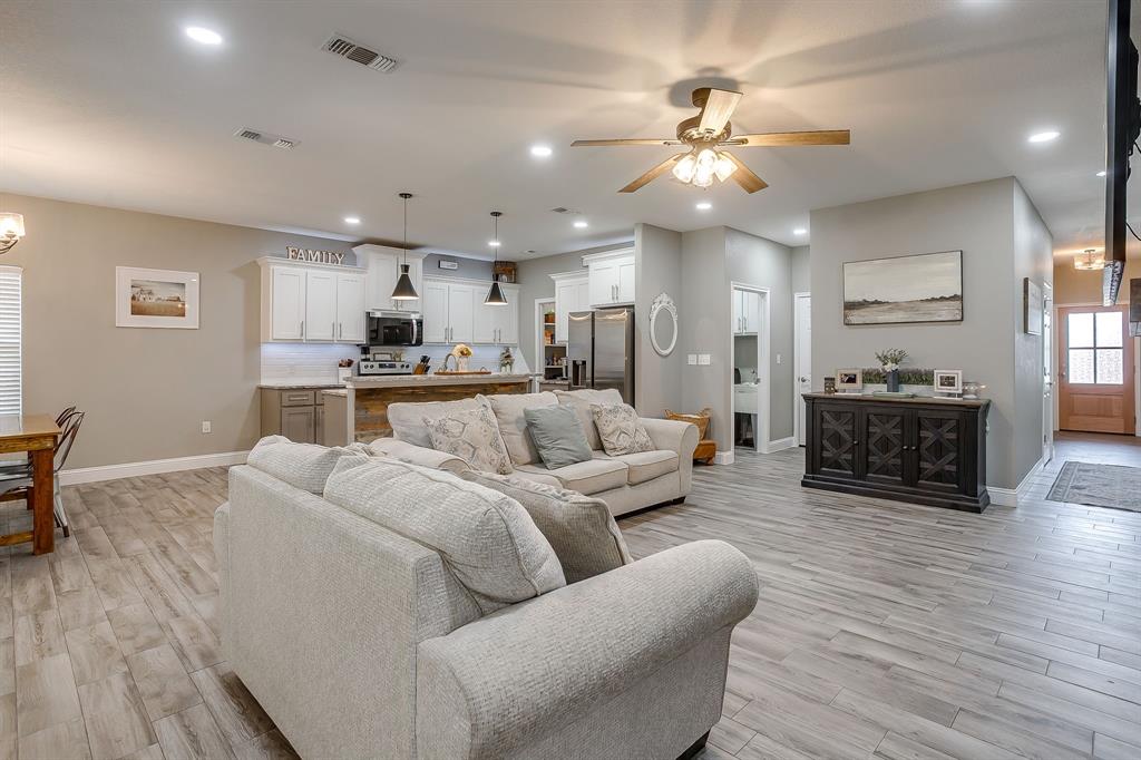 409 Titus Drive Springtown, TX 76082 - Photo 6 of 39 a living room with furniture and a wooden floor