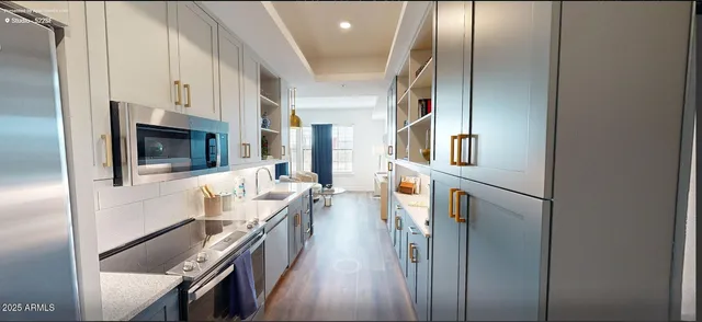 a kitchen with stainless steel appliances granite countertop a refrigerator and a stove