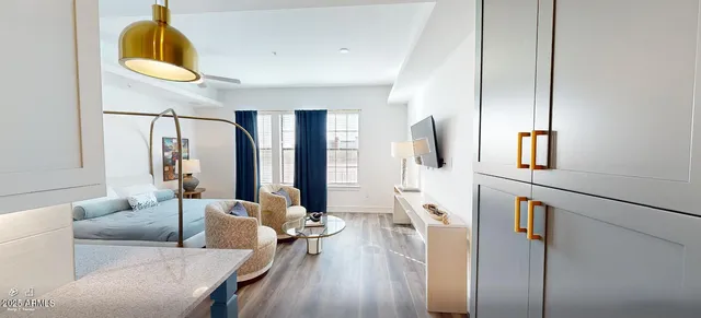 a living room with furniture and wooden floor