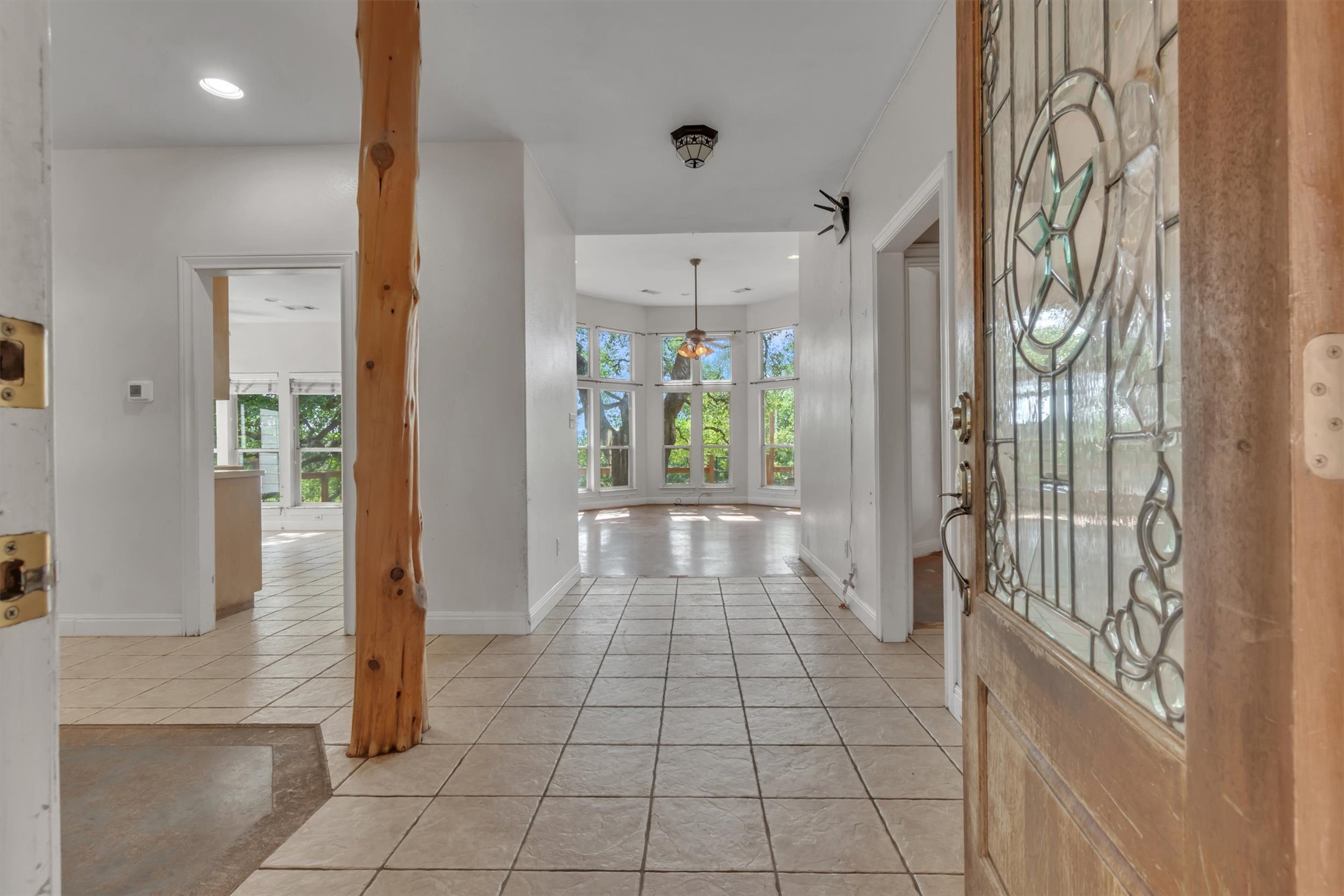 1120 Meadow Ridge Drive Austin, TX 78737 - Photo 6 of 40 A spacious entrance with tiled flooring welcomes you, leading to a vibrant living area with an abundance of natural light.