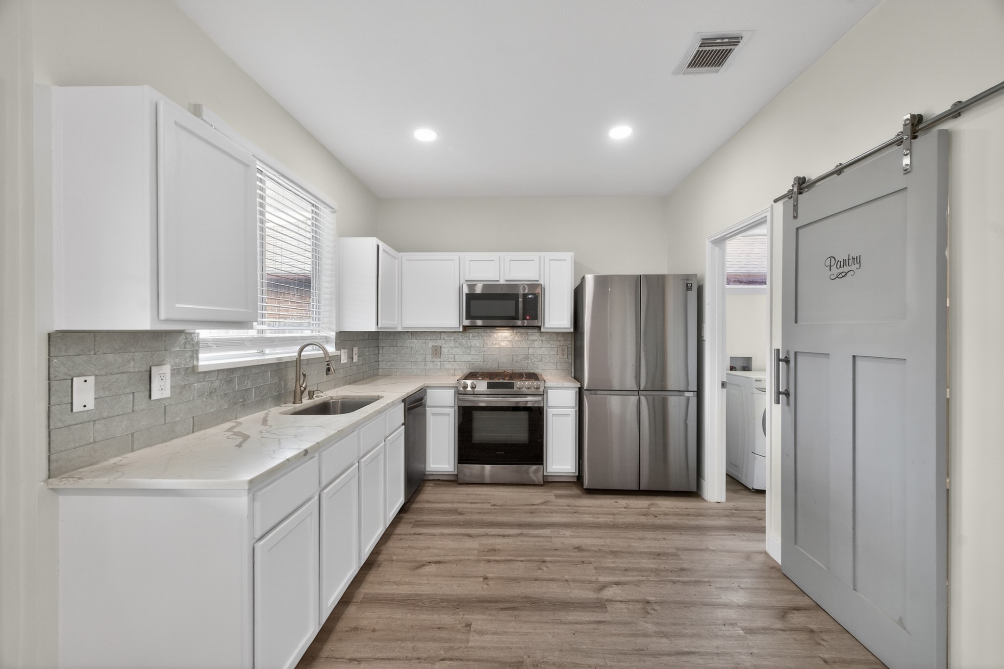918 Ivycroft Lane Spring, TX 77373 - Photo 12 of 33 a kitchen with stainless steel appliances granite countertop a refrigerator and a sink