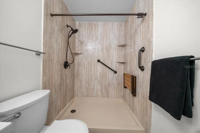 a bathroom with a sink a toilet and a shower