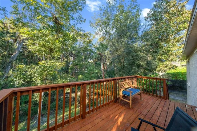 a patio with wooden floor and outdoor seating