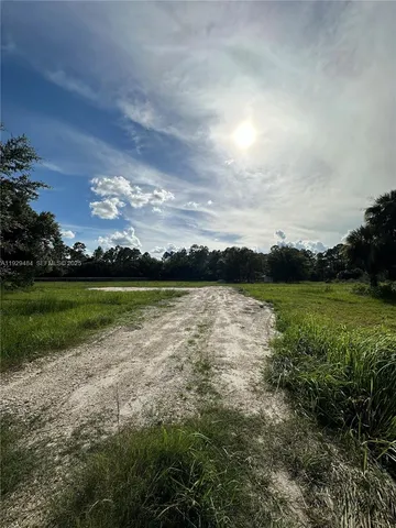 a view of a golf course with outside space