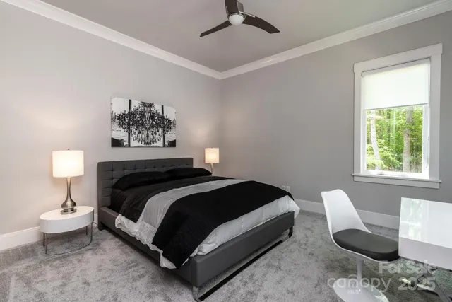 a bedroom with a bed and a painting on the wall