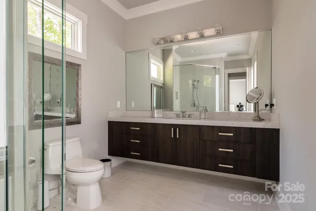 a bathroom with a toilet a sink and mirror