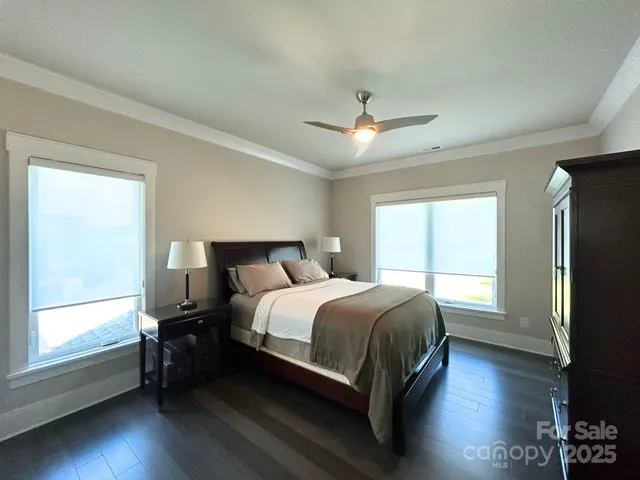 a bedroom with a bed tv and window
