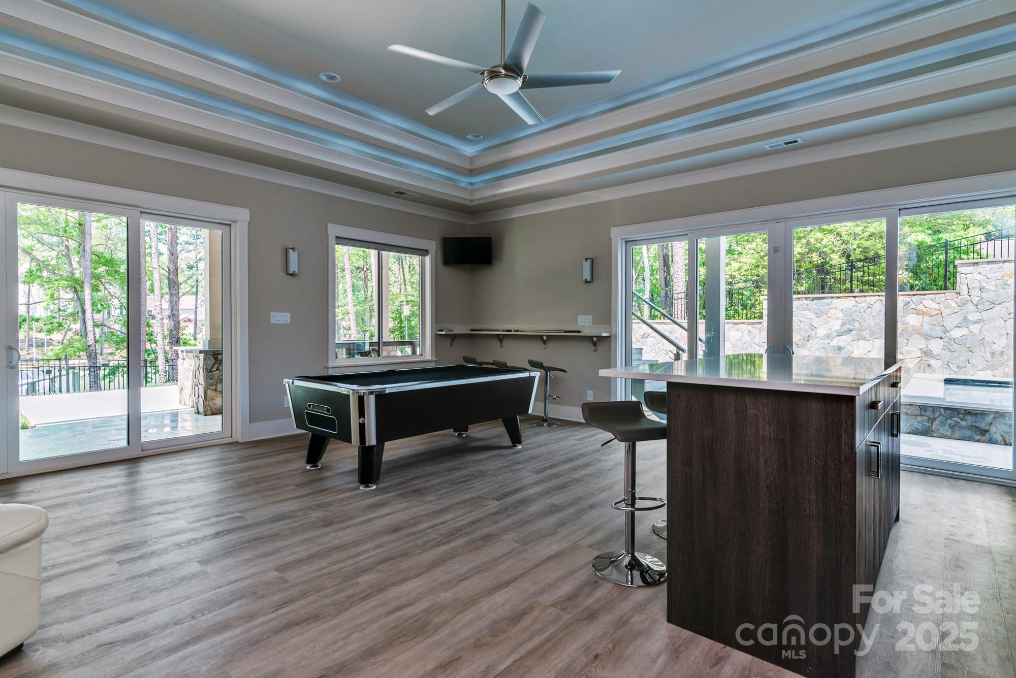4067 Rivendell Road Denver, NC 28037 - Photo 22 of 37 a living room with furniture a wooden floor and a large window