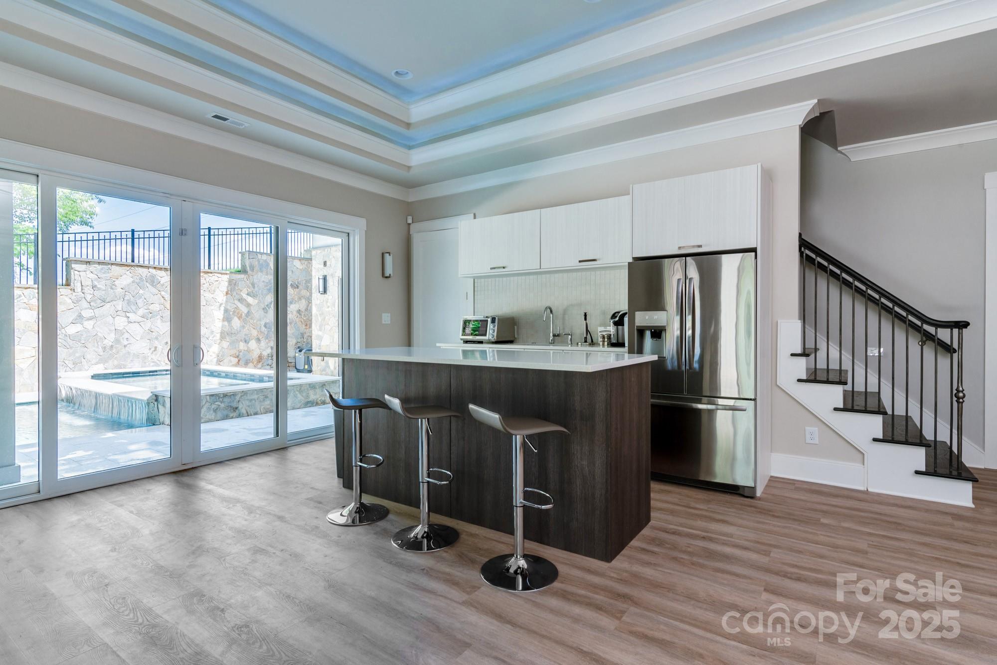 4067 Rivendell Road Denver, NC 28037 - Photo 23 of 37 a kitchen with stainless steel appliances granite countertop a refrigerator a stove a sink and white cabinets with wooden floor