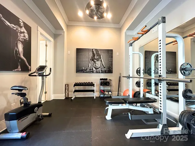a room with gym equipment and a flat screen tv