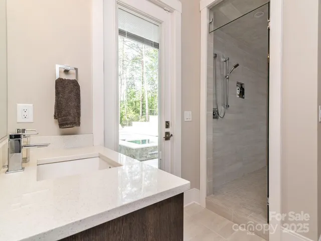 a bathroom with a bathtub sink and mirror