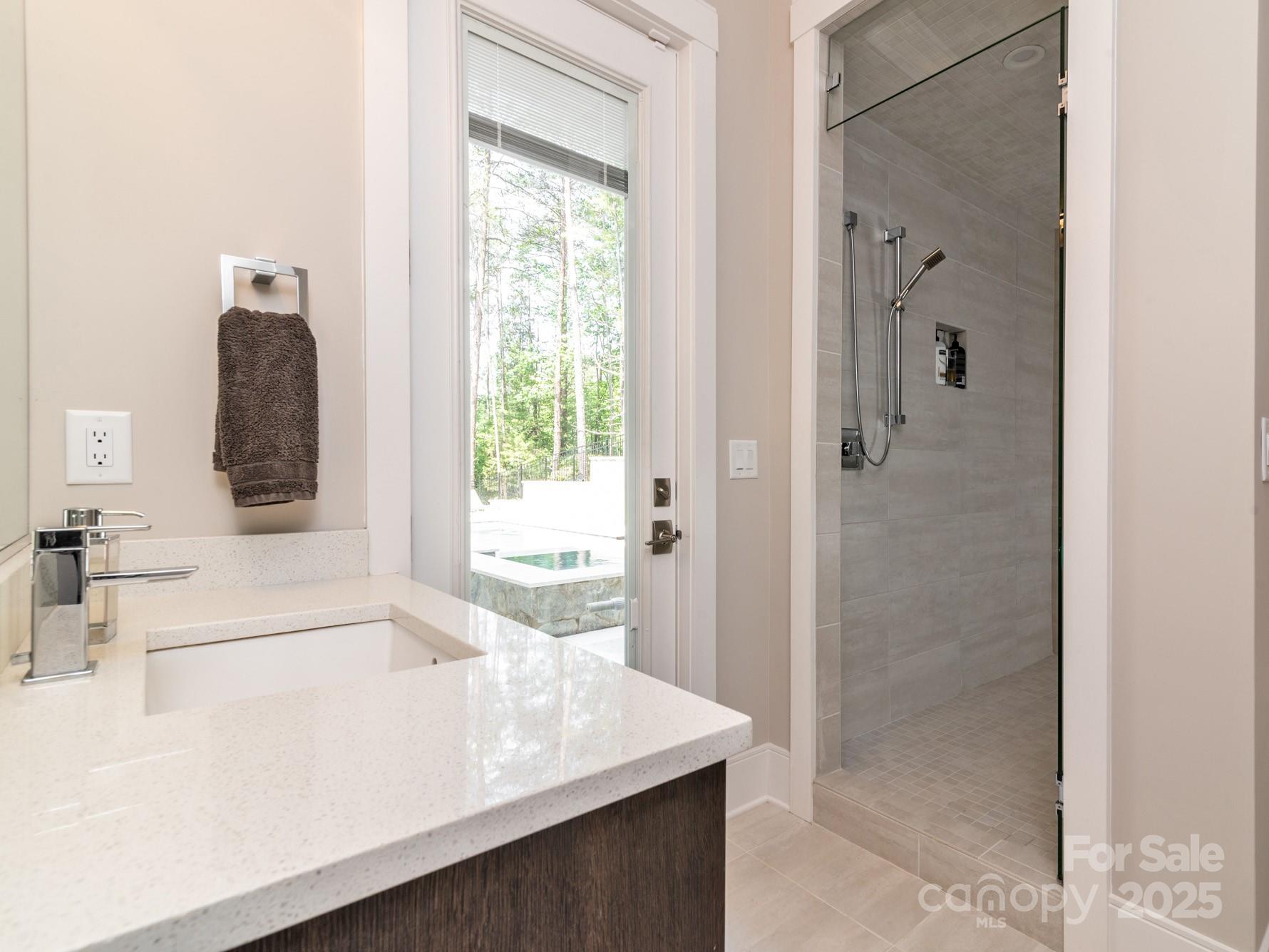 4067 Rivendell Road Denver, NC 28037 - Photo 26 of 37 a bathroom with a bathtub sink and mirror