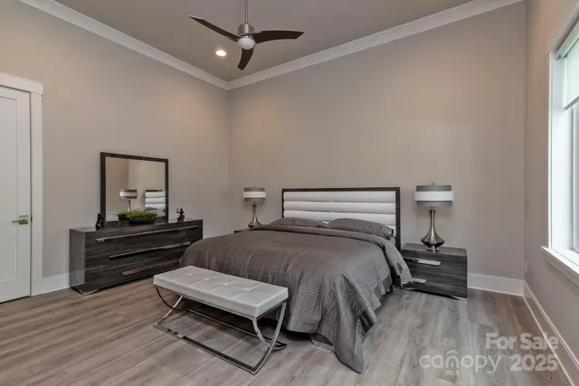 a bedroom with a bed and wooden floor