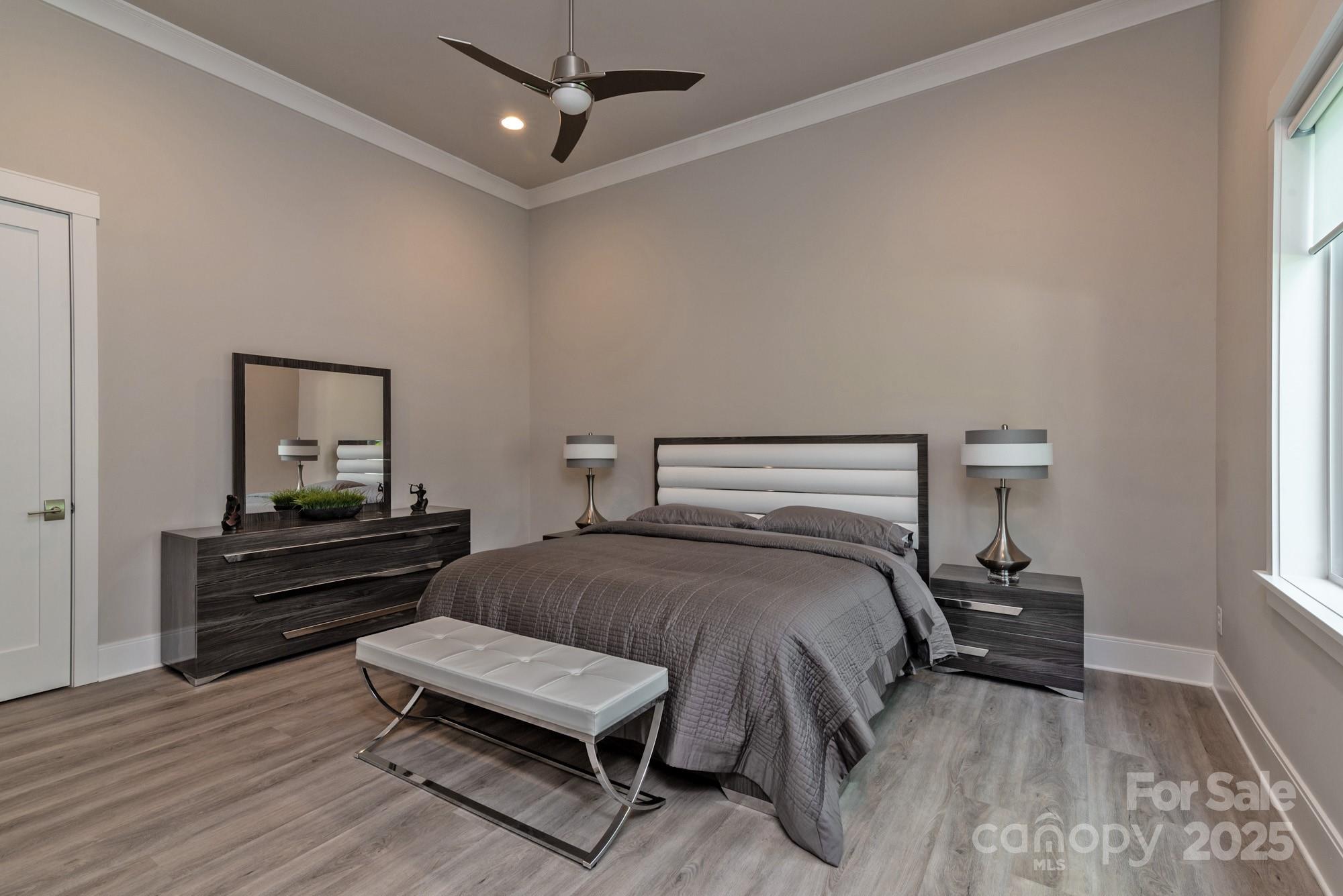 4067 Rivendell Road Denver, NC 28037 - Photo 27 of 37 a bedroom with a bed and wooden floor