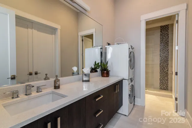 a bathroom with a double vanity sink a and a mirror